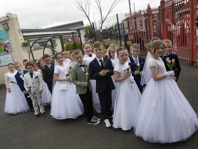 Holy Child PS First Holy Communion pupils pictured before the school's Annual May Procession with Bishop Donal McKeown to St. Mary's Church on Thursday morning. Jim McCafferty Photography
