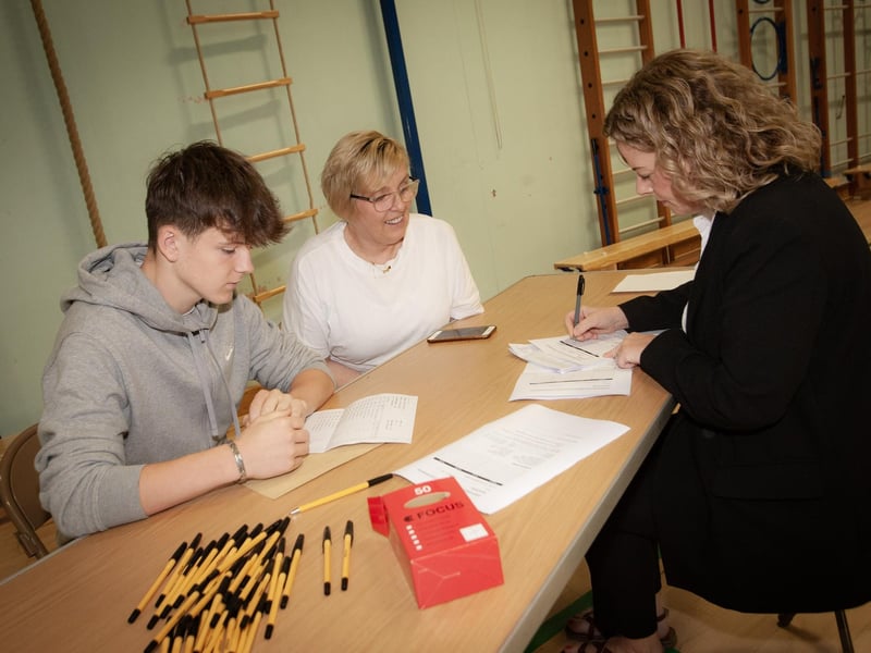 Mrs. Fiona Harigan, Vice Principal, St. Joseph's Boys' School discussing options with GCSE student Callum Watkins and his mum Ann, after receiving his results on Thursday. (Photos: Jim McCafferty Photography)