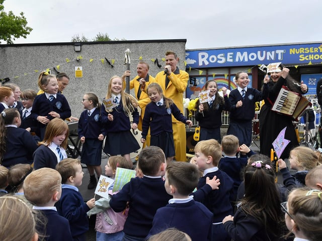 Pupils from Rosemount Primary School sing with the Jive Aces during the band’s visit to the school on Thursday morning. Photo: George Sweeney