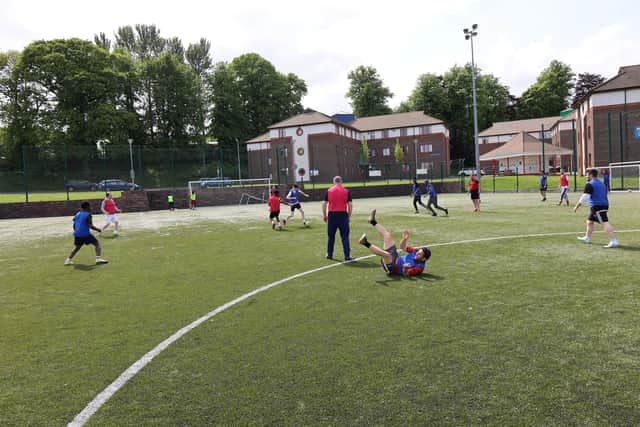 Fun and falling over…A Street Soccer match in full flow at the Magee campus, Duncreggan Student Village.