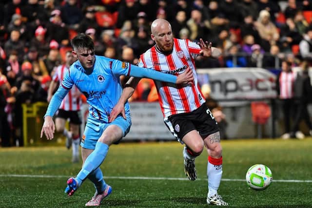 Liam Boyce of Derry City battles with Institute’s Zach McAuley. Photograph: George Sweeney