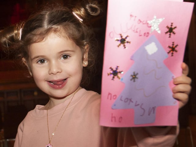 This young lady showing off her Christmas card at Saturday's Arts and Crafts.:.