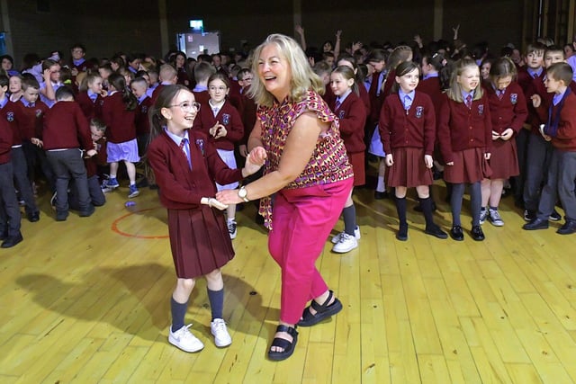 Pupils at St John’s Primary School principal Geraldine O'Connor jives with a pupil during the Jive Aces performance on Thursday afternoon. Photo: George Sweeney. DER2317GS – 26