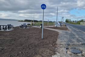 The picnic overlooking beside Lough Foyle with a covered cycle rack at Three Trees, Quigley Point.