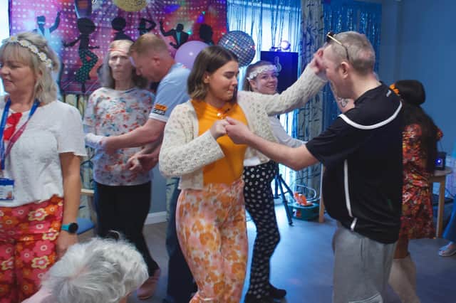 Staff, residents and families enjoying a dance