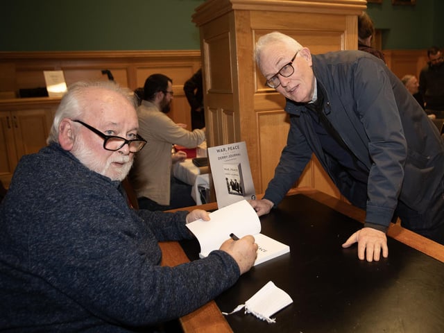 Pat pictured signing a copy for Conal McFeely.