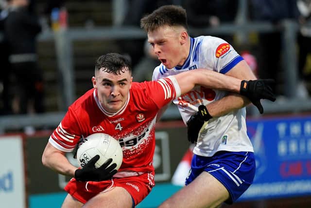 Derry’s Diarmuid Baker keeps Ciaran McNulty of Monaghan at arm’s length. Photo: George Sweeney