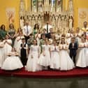 Pupils from Oakgrove PS, Lisnagelvin PS and Ebrington PS who received the Sacrament of First Holy Communion from Fr. Patrick Lagan at St. Columb's Church, Chapel Road on Thursday afternoon last. Included are principals and teachers from the three schools. (Photo: Jim McCafferty Photography)