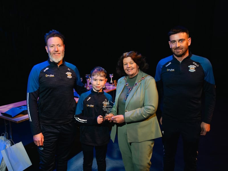 Coaches Steven Connolly and Marcus McDonald with young Noah Connolly, who captained the 2012 Colts who won the Summer Cup. Making a special presentation to the group at a Mayoral reception in The Alley Theatre is Derry City & Strabane District Council Mayor Patricia Logue. Photo: Karol McGonigle, Milkwood Studios.