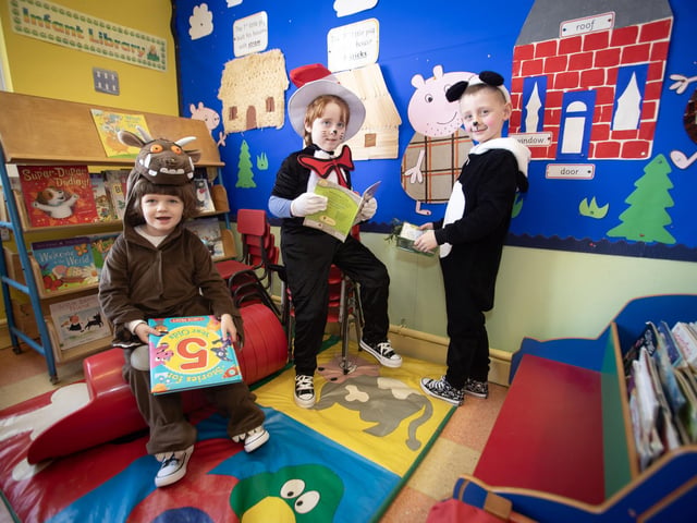 Happy readers and P2 pupils Zak, Mason and Fiachra enjoying World Book Day.