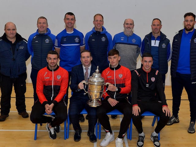 Derry City players Michael Duffy, Liam Mullan and Jordon McEneff pictured with staff St Columb's College during a visit to the school, with the FAI Cup, on Monday. Photo: George Sweeney. DER2247GS 30