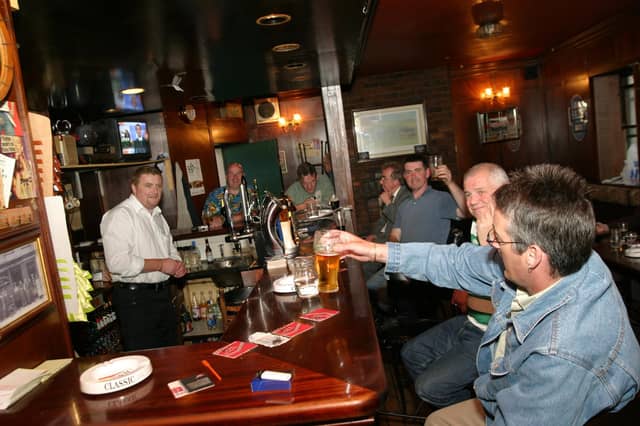 Punters enjoying a pint at the bar in Tinney's in June 2004.
