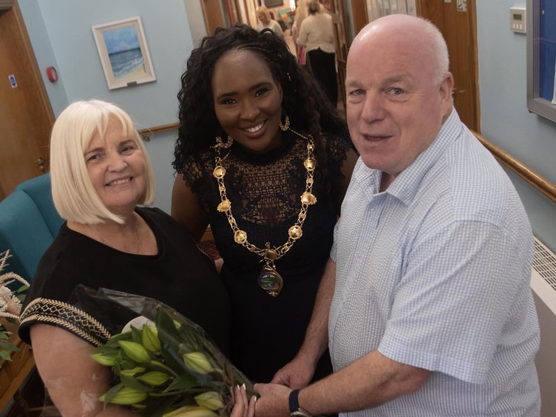 Care Home Manager Louise Carroll getting a surprise bouquet of flowers from her husband Hugh during Thursday's celebrations. Centre is the Mayor, Lillian Seenoi-Barr.