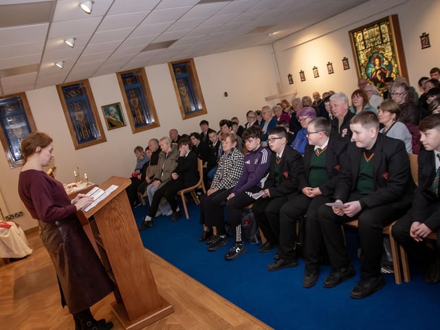 Mrs. Fiona Page, teacher, reading during Grandparents To School Mass at St. Joseph's Boys School on Wednesday. : .