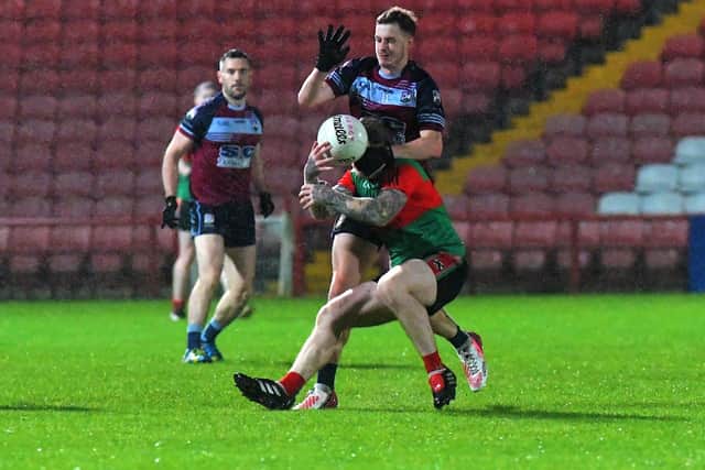 Glack ‘s Finbar O’Brien gets a grip on Eoghan Quigg of Derry Trasna during Friday evening’s JFC quarter-final in Celtic Park. Photo: George Sweeney