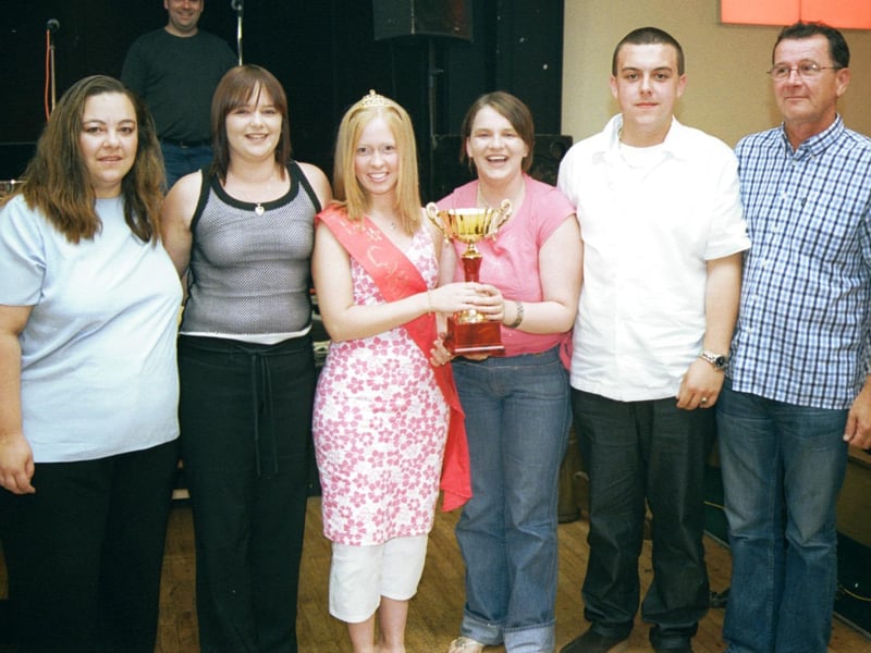 Lorraine Darcy, the Golden Link Festival Queen, presents the 'Born Again Virgins' team with their trophy after their victory in the Delacroix. Also included in photograph is quizmaster Jimmy Doherty. 190803HG9