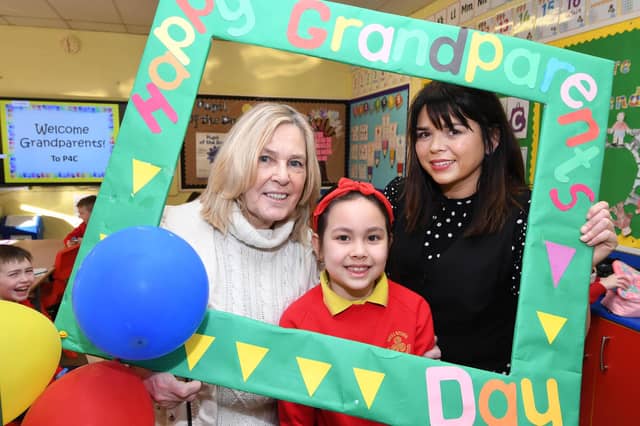 Ita grabs a photo with her grandma and Mrs. Doorish on Wednesday.