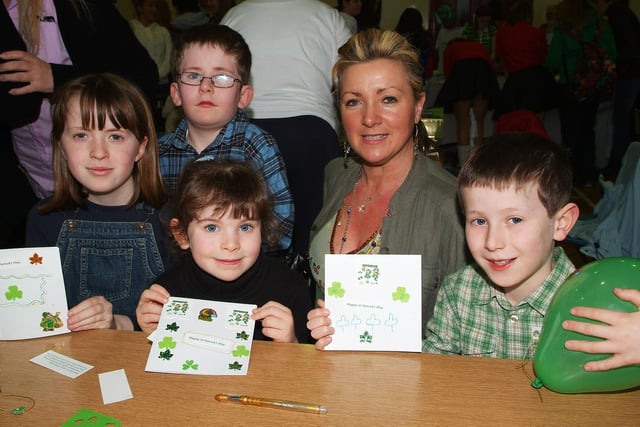 Louise McElhinney, tutor, pictured with Maria McGroddy, Ruth McLaughlin, Gavin McLaughlin and Oisin McLaughlin, who enjoyed making St. Patrick's Day cards at the Celebration of St. Patrick event held by the Shared City Project and Derry City Council Community Relations on Saturday. LS12-109KM