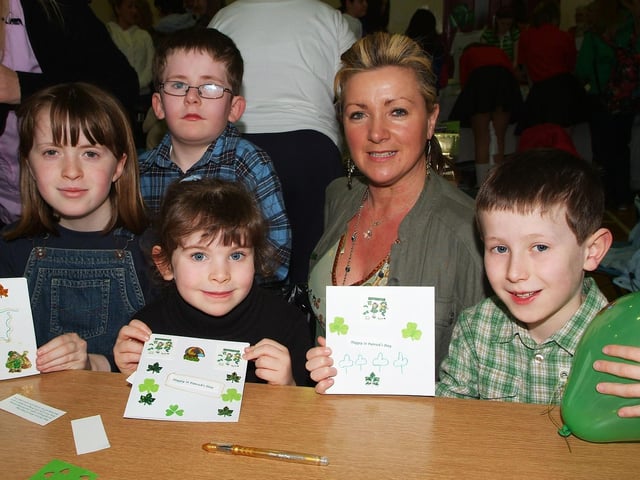 Louise McElhinney, tutor, pictured with Maria McGroddy, Ruth McLaughlin, Gavin McLaughlin and Oisin McLaughlin, who enjoyed making St. Patrick's Day cards at the Celebration of St. Patrick event held by the Shared City Project and Derry City Council Community Relations on Saturday. LS12-109KM