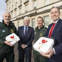 Education Minister Paul Givan is pictured with Fearghal McKinney, Head of the British Heart Foundation Northern Ireland, and members of the Northern Ireland Ambulance Service.