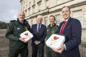Education Minister Paul Givan is pictured with Fearghal McKinney, Head of the British Heart Foundation Northern Ireland, and members of the Northern Ireland Ambulance Service.