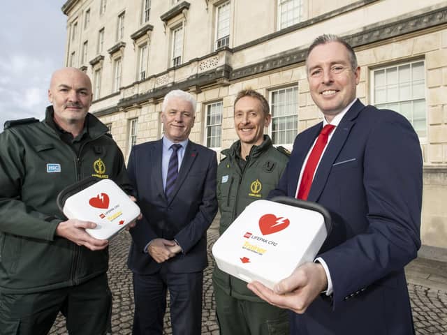 Education Minister Paul Givan is pictured with Fearghal McKinney, Head of the British Heart Foundation Northern Ireland, and members of the Northern Ireland Ambulance Service.