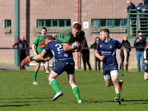 City of Derry’s Stephen Corr is intercepted during the Junior Cup against Ballynahinch on Saturday afternoon. Photo: George Sweeney. DER2312GS – 55