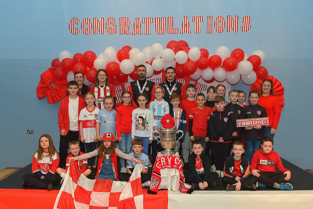 Derry City defenders Daniel Lafferty and Ciaran Coll pictured with Mrs Concaghan's P5 class and the FAI Cup at St Eithnes Primary School on Wednesday morning. Photo: George Sweeney.  DER2246GS  085