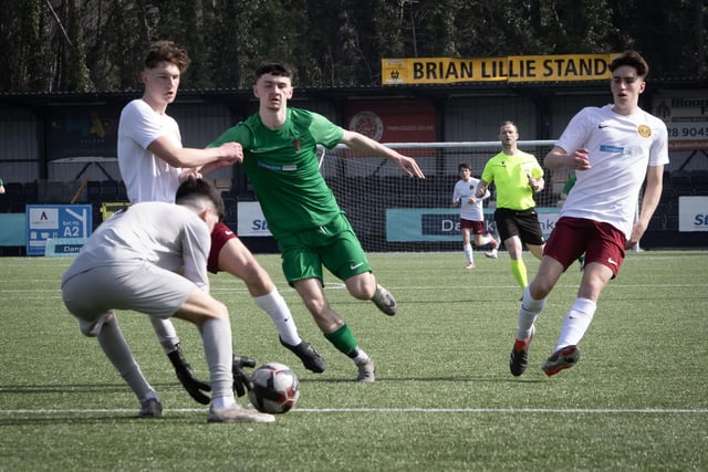 St. Joseph's Tommy McLaughlin is held off by the Dungannon centre back as he attempts to get to the ball before the goalkeeper.