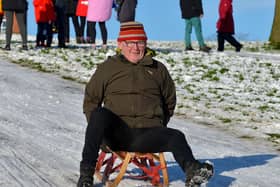 John McHugh sliding in a snow covered Brooke Park on a snowy day past.  Photo: George Sweeney / Derry Journal.  DER2104GS – 025