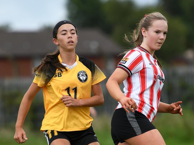 Derry City Ladies under-15's defender Rhia Black steers the ball to safety under pressure from Gundo FC forward Saya Elliott.