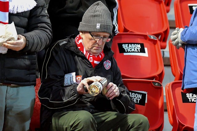 A Derry City fan pours himself a cuppa before Derry City’s game against Cork City on Friday evening. Photo: George Sweeney. DER2308GS – 139