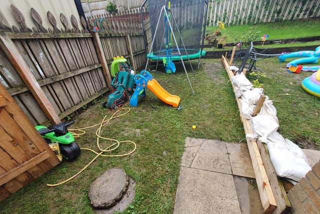 The back garden of a family home where a sewage pipe has burst on five occasions. The family have had to dispose of all the kids toys, as well as a lawnmower but have received no compensation from NI Water.