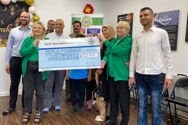 Members of the North West Islamic Association hand over a cheque of £2,100 to Karen Mullan of the Foyle Foodbank.