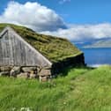 A boat shed at Hvítanes. The island of Eysturoy can be seen in the distance.