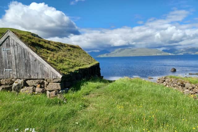 A boat shed at Hvítanes. The island of Eysturoy can be seen in the distance.