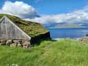 A boat shed at Hvítanes. The island of Eysturoy can be seen in the distance.