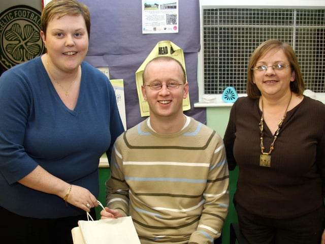 Frances Moran and Claire Thompson make a presentation to John 0013JML : Parties and celebrations March 2006: John Leonard.