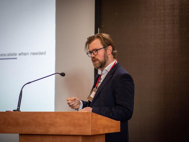 Dr Conor O'Neill, Consultant Oncologist at the North West Cancer Centre presenting on recent advancements in breast cancer research at the Hive Cancer Support World Cancer Day Conference.