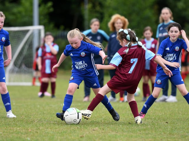 Carrie King, Buncrana Hearts, and Lily Patterson, Newbuildings United, tussle for the ball during their girls under-9's match.