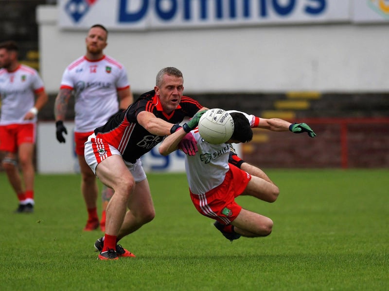 October 2023: Sean Dolan’s Conor McCosker is tackled by Ballerin’s Brian Deighan at Celtic Park in the Derry Junior Quarter-final. Photo: George Sweeney