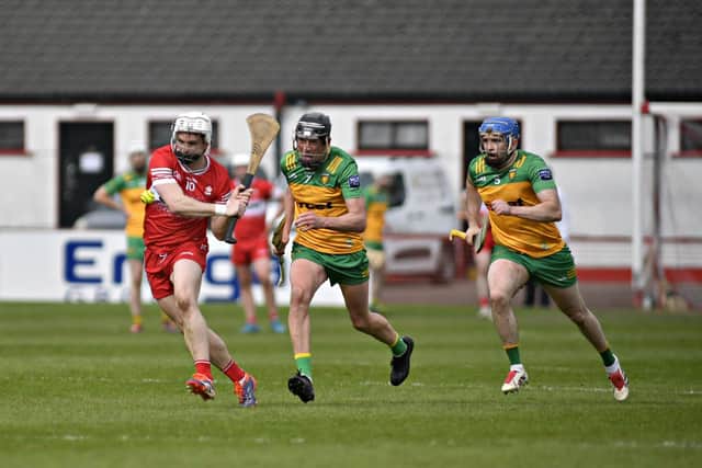 Donegal pair Danny Cullen and Conor O’Grady chase after  Derry’s Cormac O’Doherty. Photo: George Sweeney