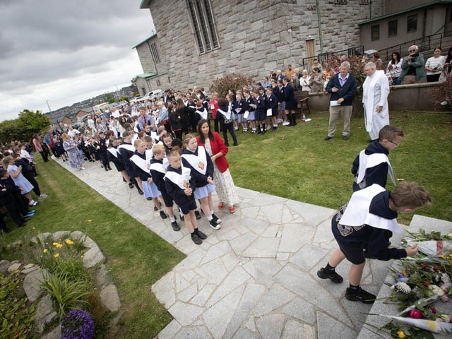 Holy Child PS Confirmation pupils picturded laying flowers at the grotto on Thursday.