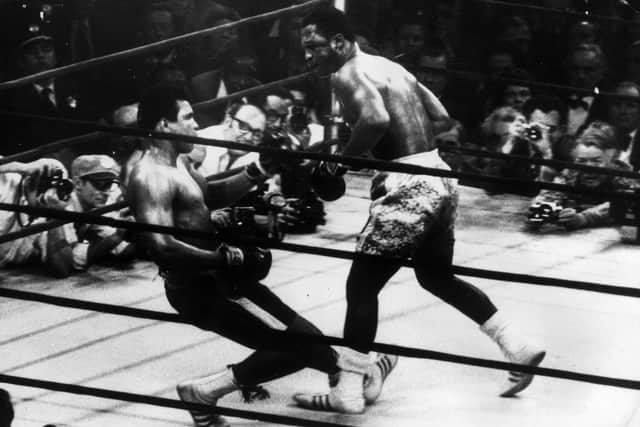 March 1971:  In a title fight at Madison Square Gardens, New York, Muhammad Ali goes down in the 15th round to a left hook from world heavyweight champion Joe Frazier who kept the title with an unanimous points win. Cameramen are crowded round the ring.  (Photo by Keystone/Getty Images)