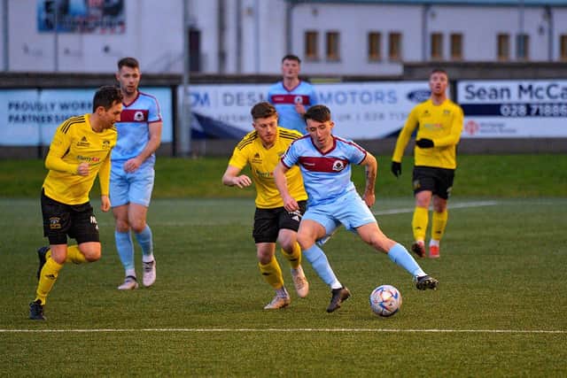Institute's Jack McFeely takes control in midfield against Annagh United.