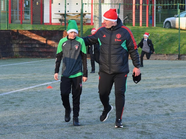 Patrick and Mr Parkhouse (Manchester United Foundation) complete the Santa's Run together on Tuesday.