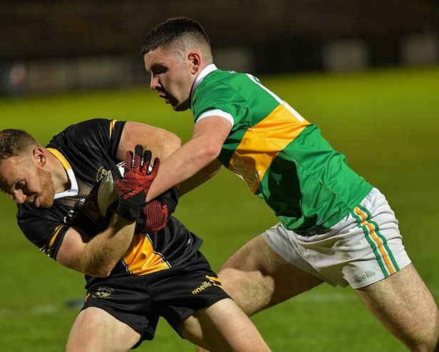 Ballymaguigan ‘s Pearce O’Neill, pictured grappling with Moneymore’s Mark Bell, hit 0-5 against Cavan champions, Arva.  Photo: George Sweeney