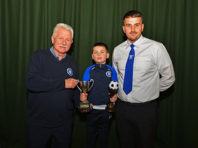 Club Player of the Year, Logan Duffy, receives his trophy from Chairperson Paddy McLaren and vice-chairperson, Diolian Ward, at the Trojans FC annual Youth Presentation held in St Cecilia’s College. Photo: George Sweeney