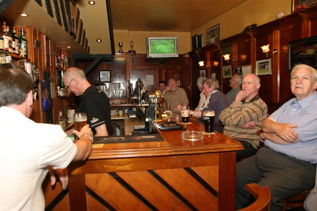 Punters enjoying a pint and good company while watching a match in the Alleyman's.