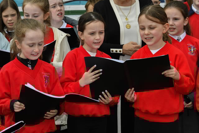 Pupils from St Eugene's Primary School's choir sing 'All Kinds of Everything' at the mural of St Columba, in Columbcille Court, celebrating the patron saint of Derry's feast day. Photo: George Sweeney